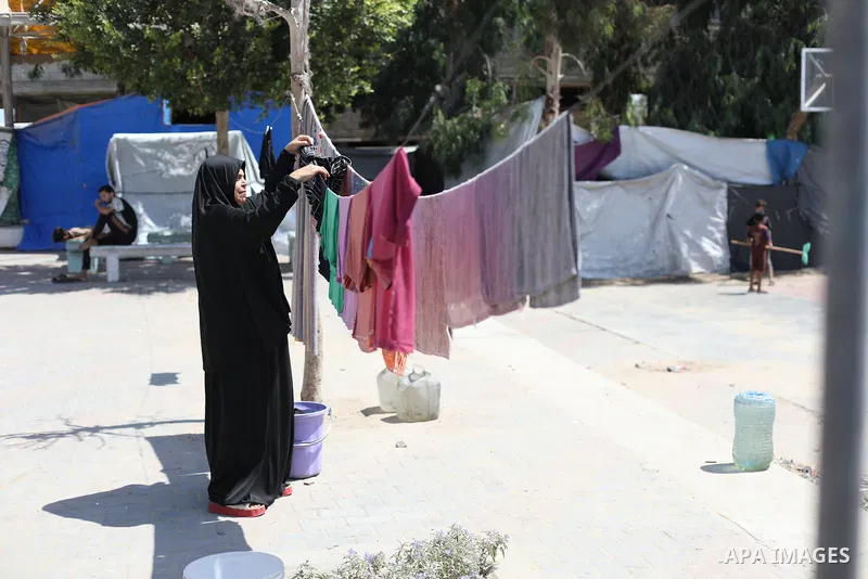 Displaced Palestinians live in tents inside a school converted into a shelter in the Nuseirat refugee camp, central Gaza Strip, on August 17, 2026, after being forced to leave their homes due to the war and being unable...