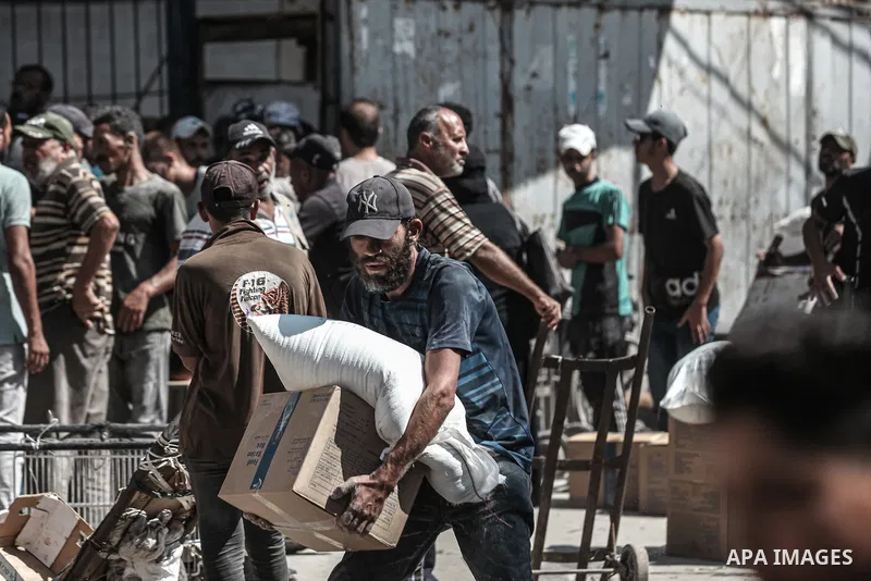 Palestinians receive food assistance distributed by the World Food Programme (WFP) in the Nuseirat refugee camp, central Gaza Strip, on August 19, 2026, amid the continuing humanitarian crisis and growing basic needs. Th...