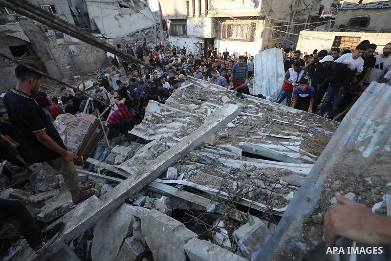 Palestinians gather at the site of an Israeli strike that targeted a house in al-Bureij refugee camp in the central Gaza Strip on August 24, 2026. Local sources said the strike killed a child and wounded other residents....
