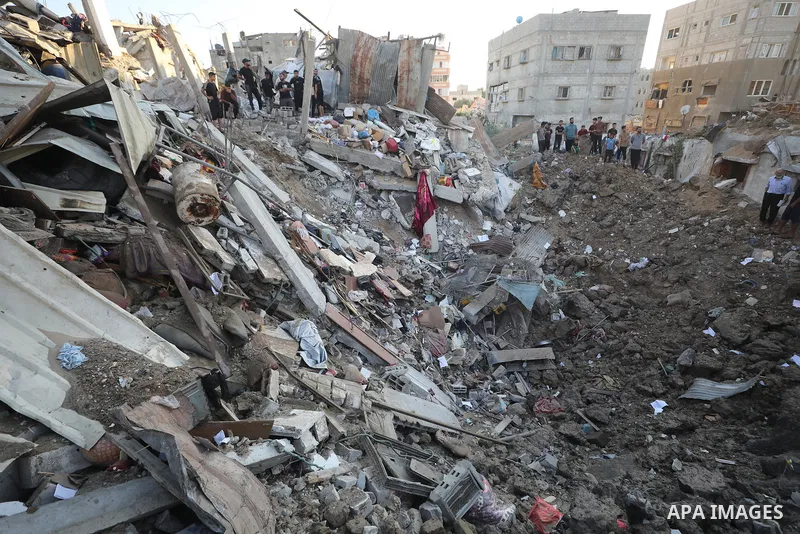 Palestinians gather at the site of an Israeli strike that targeted a house in al-Bureij refugee camp in the central Gaza Strip on August 24, 2026. Local sources said the strike killed a child and wounded other residents....