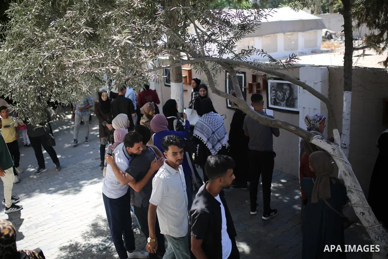 Palestinians attend the “Brush of Peace” exhibition featuring artworks and drawings by young women from Gaza City on August 30, 2026. The exhibition highlights artistic expression amid wartime conditions and presents the...