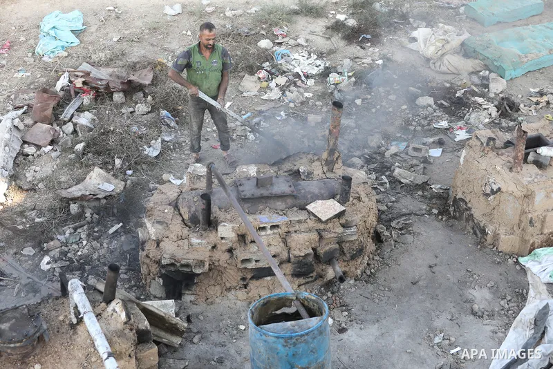 Palestinian workers produce fuel from plastic waste using rudimentary methods at the Nuseirat refugee camp in the central Gaza Strip on September 2, 2026. The process continues amid ongoing fuel shortages and restriction...