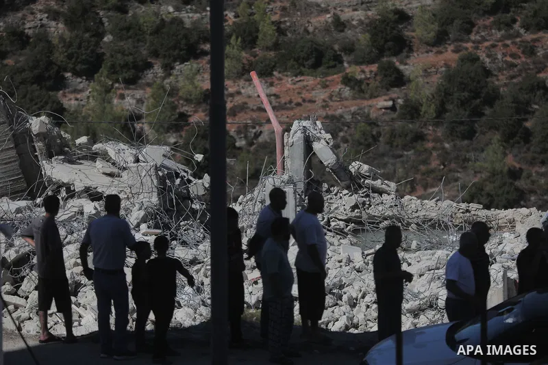 Heavy machinery accompanied by Israeli forces demolishes a Palestinian building, as Palestinians inspect the rubble afterward, in the town of Battir, west of Bethlehem, in the occupied West Bank, on September 10, 2026. P...