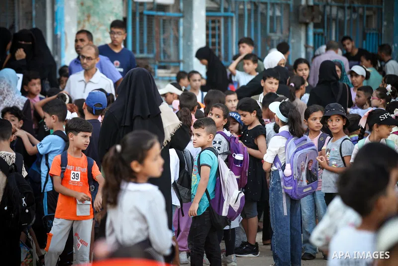 Palestinian students head to school at the start of the new academic year in al-Bureij camp in the central Gaza Strip on September 19, 2026, where some classes are being held in tents and damaged school buildings. Thousa...