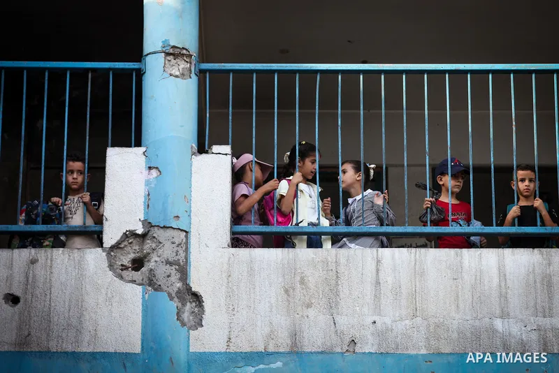 Palestinian students head to school at the start of the new academic year in al-Bureij camp in the central Gaza Strip on September 19, 2026, where some classes are being held in tents and damaged school buildings. Thousa...