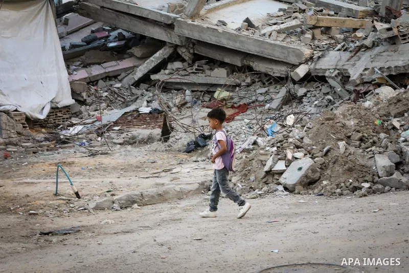 Palestinian students head to school at the start of the new academic year in al-Bureij camp in the central Gaza Strip on September 19, 2026, where some classes are being held in tents and damaged school buildings. Thousa...