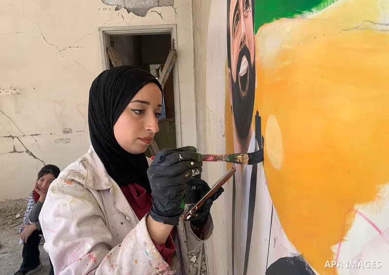 Palestinian artist Aseel Nasman creates artwork on the rubble of destroyed homes in the Gaza Strip on September 24, 2026. Nasman uses her art to portray international figures who have expressed support for Palestinians,...