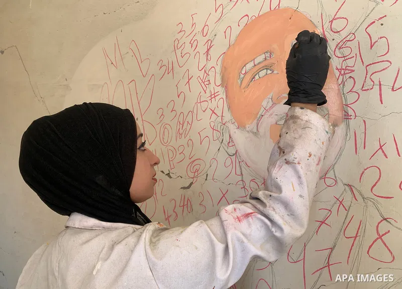 Palestinian artist Aseel Nasman creates artwork on the rubble of destroyed homes in the Gaza Strip on September 24, 2026. Nasman uses her art to portray international figures who have expressed support for Palestinians,...
