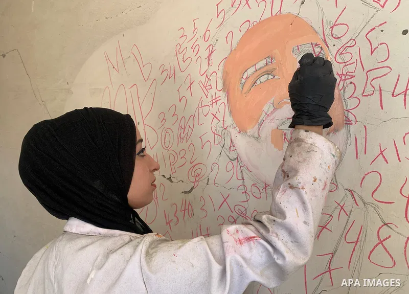 Palestinian artist Aseel Nasman creates artwork on the rubble of destroyed homes in the Gaza Strip on September 24, 2026. Nasman uses her art to portray international figures who have expressed support for Palestinians,...