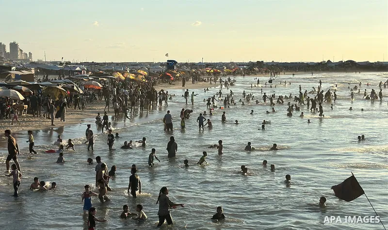 Displaced Palestinians spend time on the beach in Gaza City, in the Gaza Strip, on September 25, 2026, seeking relief from high temperatures and difficult living conditions inside displacement and shelter tents. Many dis...
