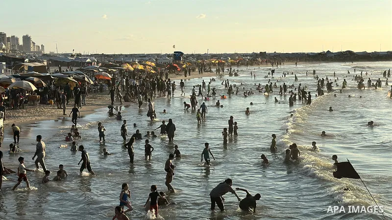 Displaced Palestinians spend time on the beach in Gaza City, in the Gaza Strip, on September 25, 2026, seeking relief from high temperatures and difficult living conditions inside displacement and shelter tents. Many dis...