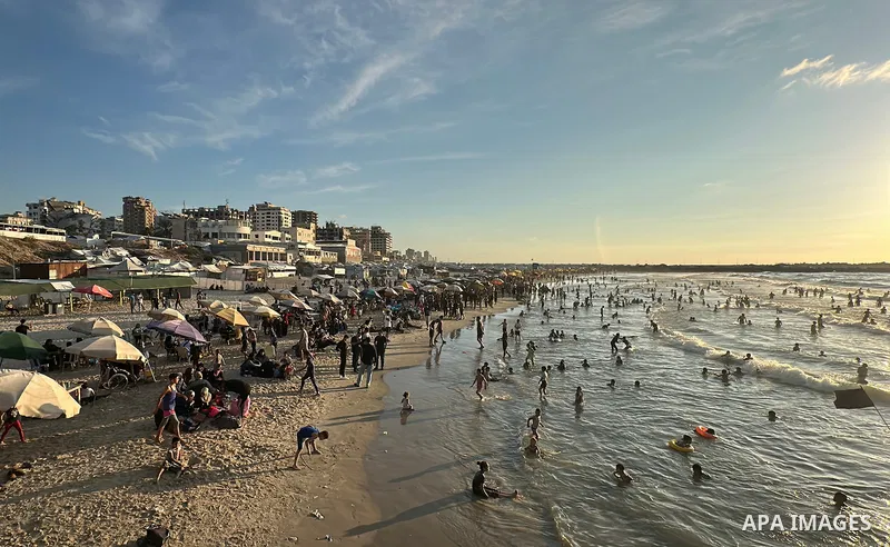 Displaced Palestinians spend time on the beach in Gaza City, in the Gaza Strip, on September 25, 2026, seeking relief from high temperatures and difficult living conditions inside displacement and shelter tents. Many dis...