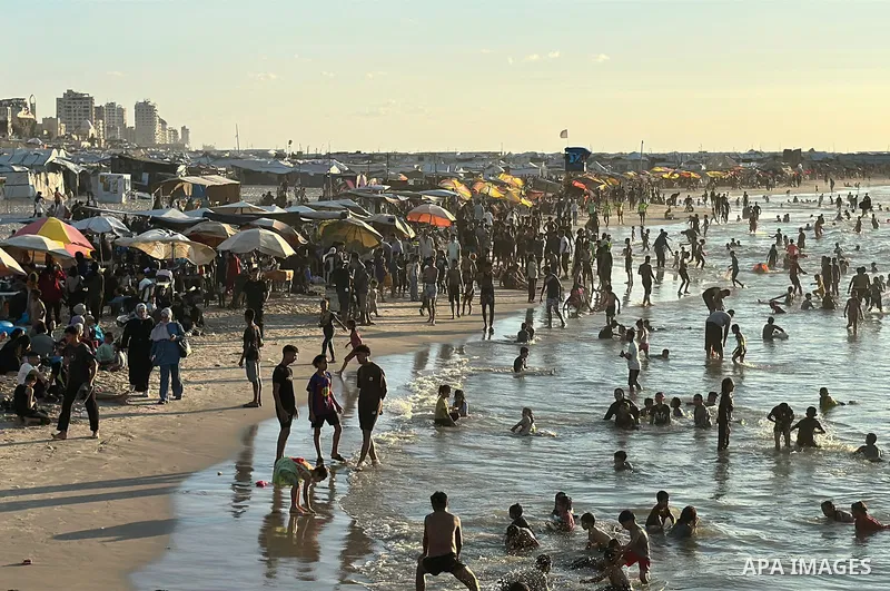 Displaced Palestinians spend time on the beach in Gaza City, in the Gaza Strip, on September 25, 2026, seeking relief from high temperatures and difficult living conditions inside displacement and shelter tents. Many dis...