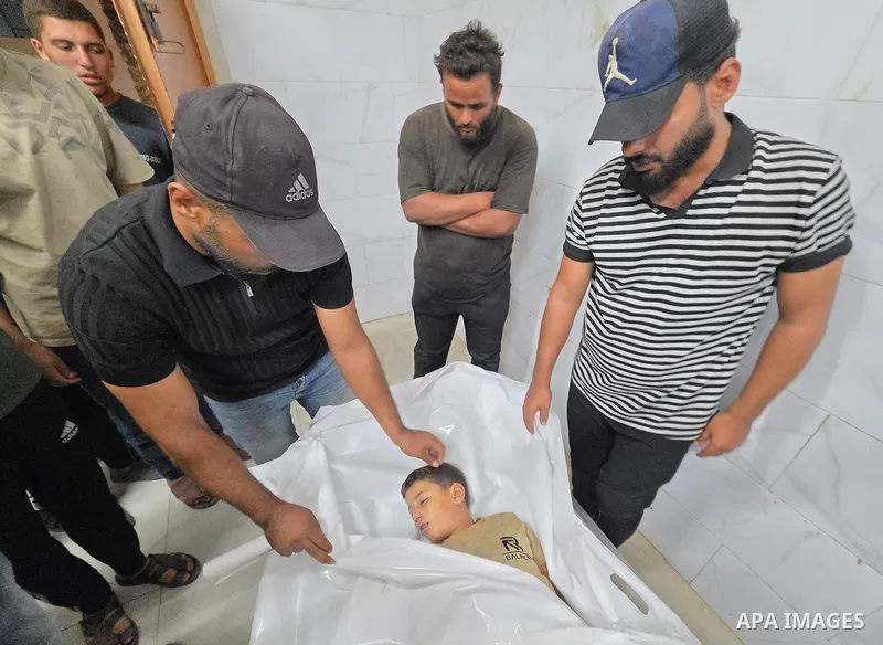 Medics carry the body of eight-year-old Mohammed Seif al-Din al-Shukhriti to Nasser Medical Complex in Khan Younis, southern Gaza Strip, on September 26, 2026, after he was killed by Israeli gunfire while playing outside...
