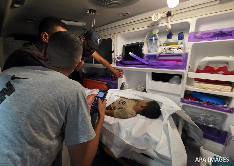 Medics carry the body of eight-year-old Mohammed Seif al-Din al-Shukhriti to Nasser Medical Complex in Khan Younis, southern Gaza Strip, on September 26, 2026, after he was killed by Israeli gunfire while playing outside...