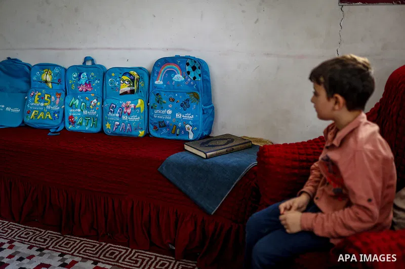 Palestinian visual artist Hala Abu Hamda, 18, paints and colors children’s bags inside her home in the al-Nasr neighborhood of Gaza City on September 27, 2026, as the new academic year begins. Students in the Gaza Strip...
