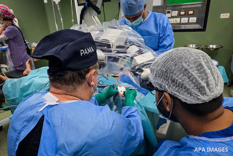 A medical team performs cochlear implant surgery on a child at Nasser Medical Complex in Khan Younis, southern Gaza Strip, on September 27, 2026. The operation is part of a project to provide similar surgeries for 50 chi...