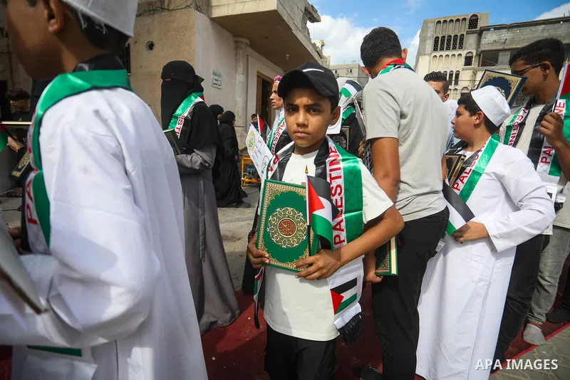 Male and female students who have memorized the Holy Koran, along with their families, take part in a ceremony honoring 250 memorizers at the Imam al-Shafi‘i Mosque in the al-Zeitoun neighborhood of Gaza City on Septembe...