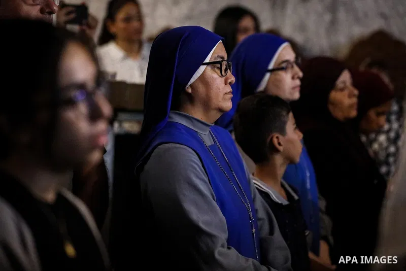 People gather during the funeral of two Palestinian Christian women at the Greek Orthodox Church of Saint Porphyrius in Gaza City, on October 3, 2026. Maysaa Khader Ibrahim Abu Daoud and her daughter, Maria Hafez Michel...