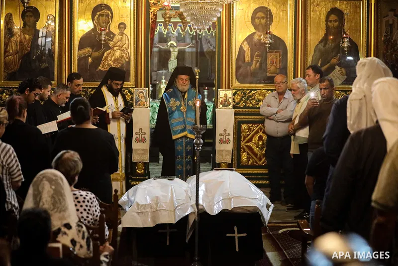 People gather during the funeral of two Palestinian Christian women at the Greek Orthodox Church of Saint Porphyrius in Gaza City, on October 3, 2026. Maysaa Khader Ibrahim Abu Daoud and her daughter, Maria Hafez Michel...