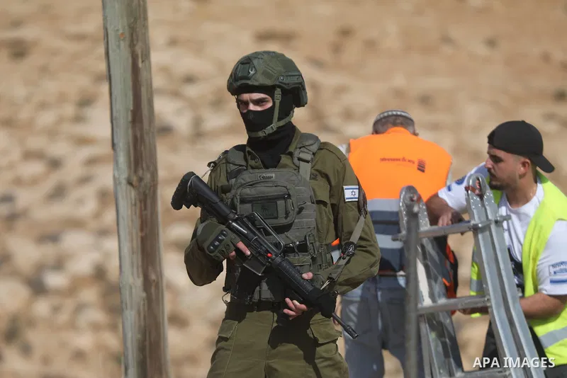 Israeli army vehicles demolish a Palestinian building in the village of al-Deirat near Yatta, south of Hebron, in the West Bank, on October 5, 2026, as Israeli forces deploy around the site and Palestinians watch the dem...