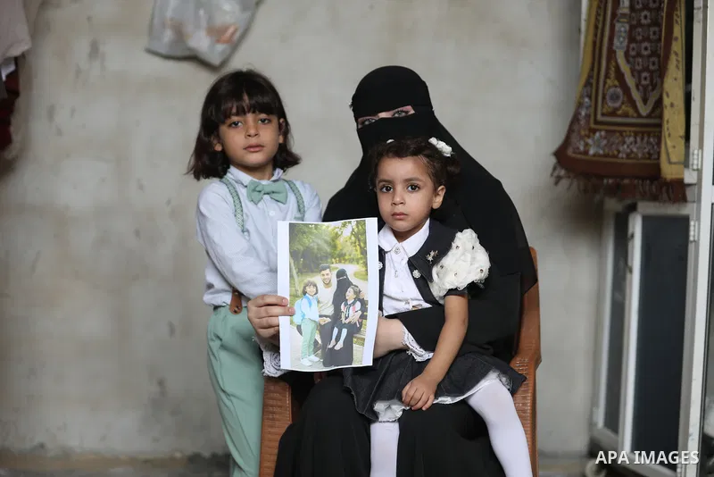 Suja Abu Rous, 25, the wife of Palestinian journalist Sari Mansour, documents daily life with her two children in al-Bureij, in the central Gaza Strip, on October 7, 2026, after her husband was killed in an Israeli airst...