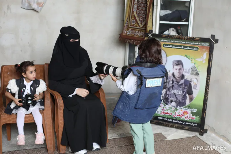 Suja Abu Rous, 25, the wife of Palestinian journalist Sari Mansour, documents daily life with her two children in al-Bureij, in the central Gaza Strip, on October 7, 2026, after her husband was killed in an Israeli airst...