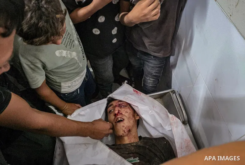 Palestinians carry the body of Ziad Zaarab to Nasser Medical Complex in Khan Younis, in the southern Gaza Strip, on October 7, 2026, after he was killed in an Israeli strike on the Qizan Rashwan area south of the city, a...