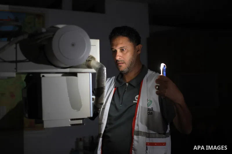 Darkened rooms are seen inside Al-Awda Hospital in the Nuseirat refugee camp, in the central Gaza Strip, on October 7, 2026, after the hospital suspended medical services due to a severe shortage of generator fuel and a...