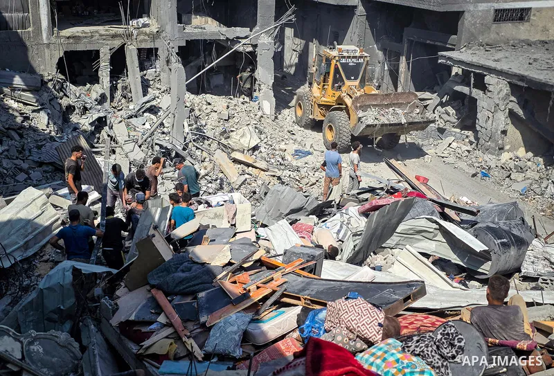 Palestinians inspect the damage in a residential block after an Israeli airstrike destroyed houses and residential apartments in Khan Younis, in the southern Gaza Strip, on October 9, 2026. Photo by Tariq Mohammad\ APA I...