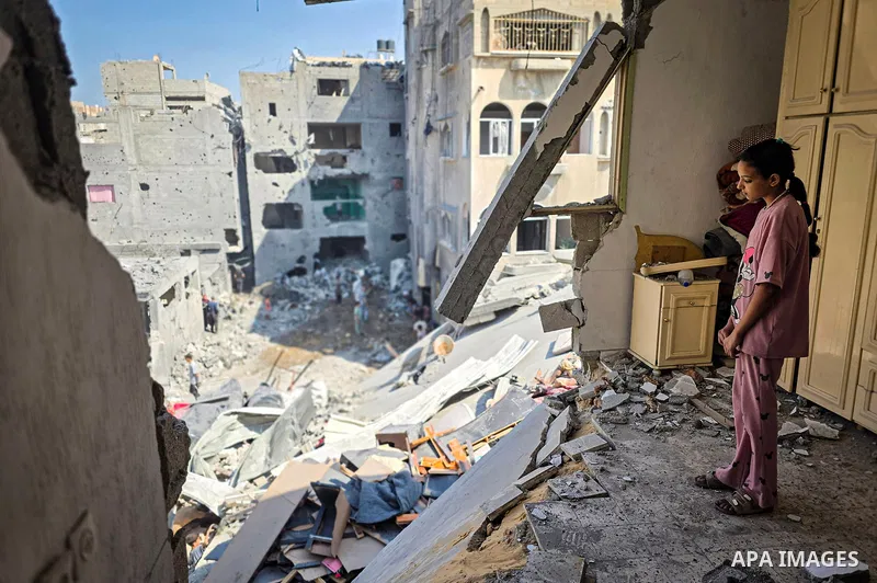 Palestinians inspect the damage in a residential block after an Israeli airstrike destroyed houses and residential apartments in Khan Younis, in the southern Gaza Strip, on October 9, 2026. Photo by Tariq Mohammad\ APA I...