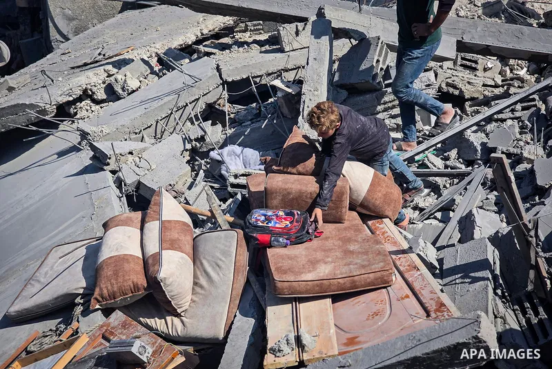 Palestinians inspect the damage in a residential block after an Israeli airstrike destroyed houses and residential apartments in Khan Younis, in the southern Gaza Strip, on October 9, 2026. Photo by Tariq Mohammad\ APA I...