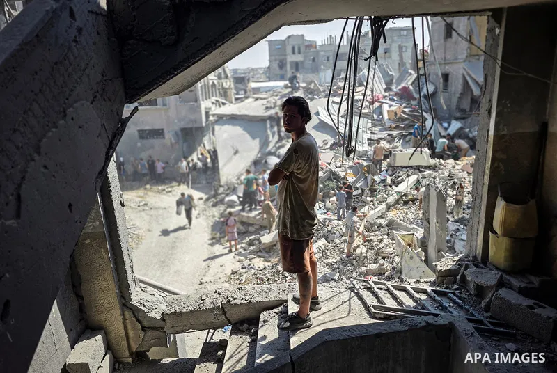Palestinians inspect the damage in a residential block after an Israeli airstrike destroyed houses and residential apartments in Khan Younis, in the southern Gaza Strip, on October 9, 2026. Photo by Tariq Mohammad\ APA I...