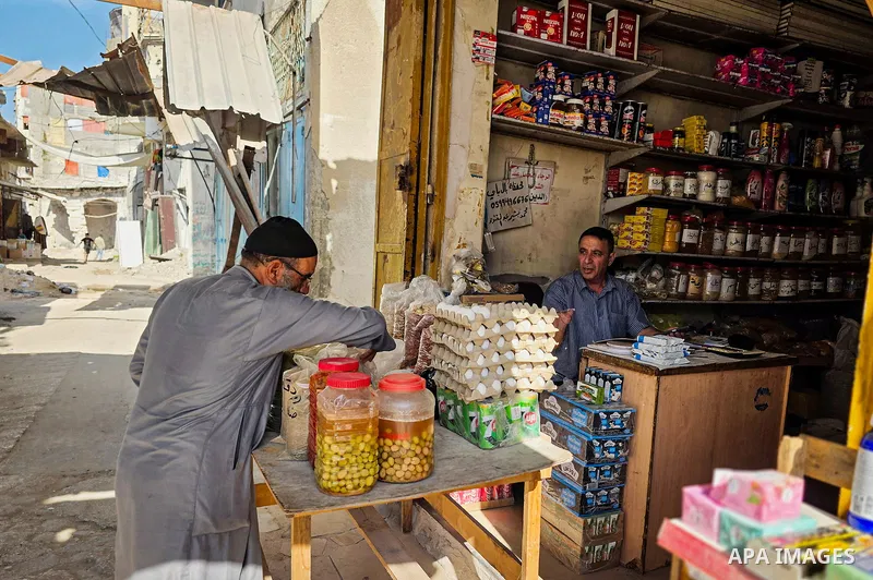 Palestinian vendors resume work at the historic grain market in Khan Younis, in the southern Gaza Strip, on October 14, 2026, where families have passed down the grain trade for around 120 years. Traders are seeking to r...