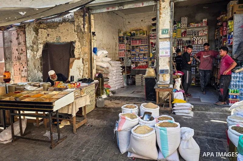 Palestinian vendors resume work at the historic grain market in Khan Younis, in the southern Gaza Strip, on October 14, 2026, where families have passed down the grain trade for around 120 years. Traders are seeking to r...