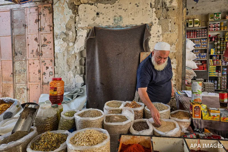 Palestinian vendors resume work at the historic grain market in Khan Younis, in the southern Gaza Strip, on October 14, 2026, where families have passed down the grain trade for around 120 years. Traders are seeking to r...