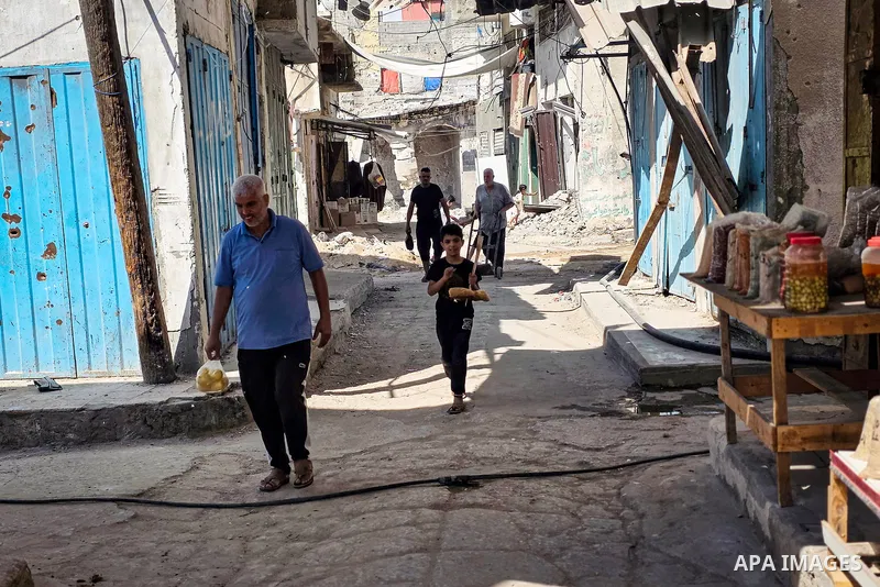 Palestinian vendors resume work at the historic grain market in Khan Younis, in the southern Gaza Strip, on October 14, 2026, where families have passed down the grain trade for around 120 years. Traders are seeking to r...