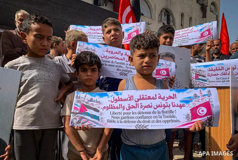 Palestinians take part in a solidarity rally at the al-Katiba displacement camp west of Gaza City on October 15, 2026, calling for the release of Global Sumud Flotilla activists and members of an aid convoy detained in T...