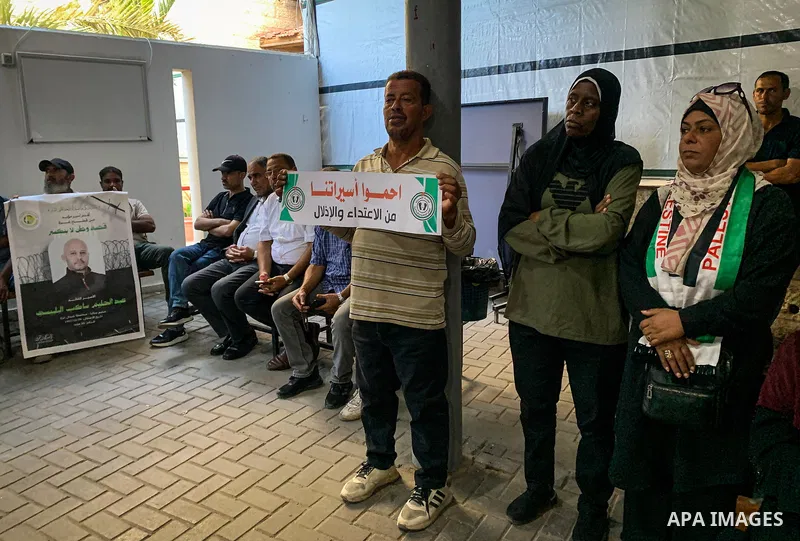 Palestinians take part in a weekly solidarity protest in support of Palestinian prisoners, including women and those suffering from illnesses, held outside the International Committee of the Red Cross (ICRC) headquarters...
