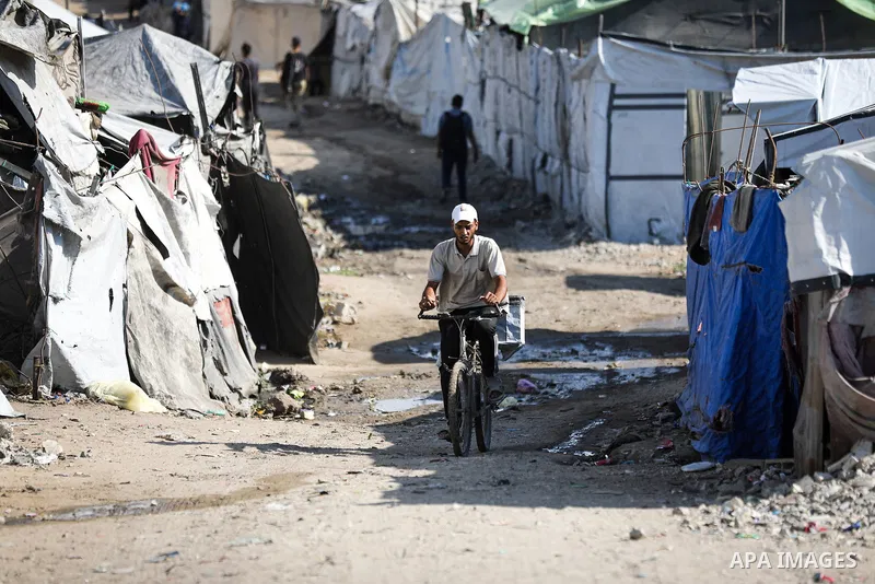 Displaced Palestinians struggle to continue their lives inside temporary tents set up near the rubble of destroyed homes in Jabalia refugee camp in the northern Gaza Strip, on October 22, 2026, amid growing fears over th...