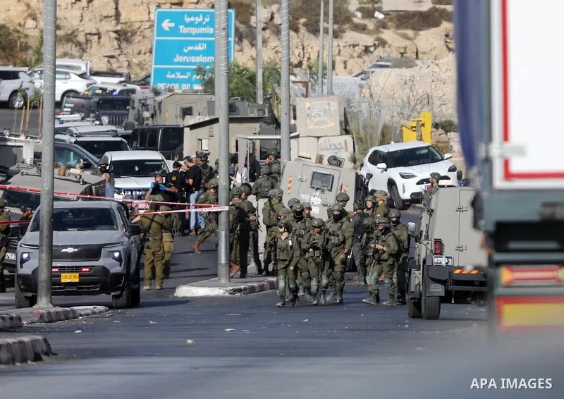 Israeli troops stand guard in the Farsh Al Hawa area at the northern entrance to Hebron, West Bank, Palestine, on October 23, 2026. Israeli troops shot and killed two Palestinians, alleging that they had carried out an a...
