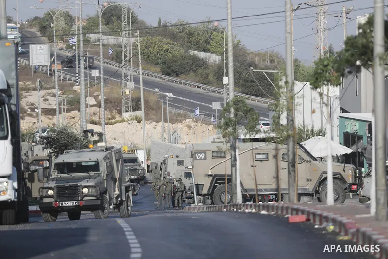 Israeli troops stand guard in the Farsh Al Hawa area at the northern entrance to Hebron, West Bank, Palestine, on October 23, 2026. Israeli troops shot and killed two Palestinians, alleging that they had carried out an a...