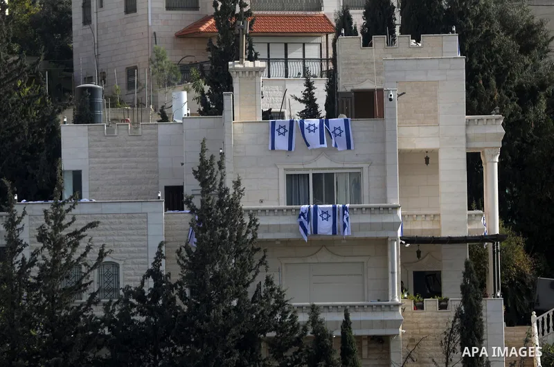 Israeli soldiers raise Israeli flags over a Palestinian home after raiding and converting it into a military post in the West Bank city of Hebron, on October 24, 2026. The incident comes amid an Israeli military operatio...