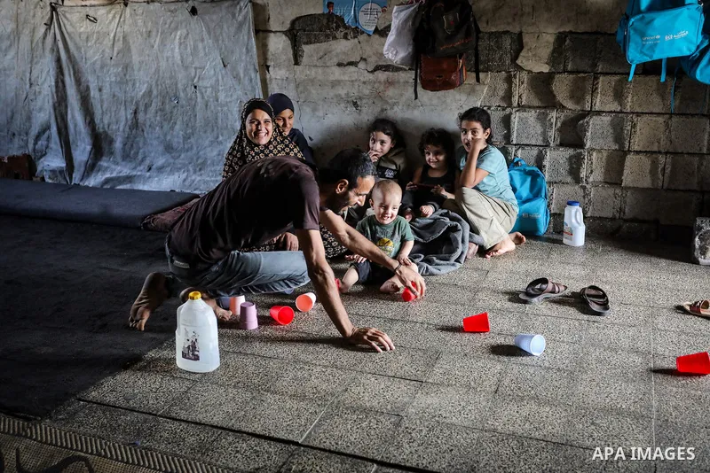 Displaced Palestinians live inside the al-Rimal school run by the United Nations Relief and Works Agency (UNRWA), west of Gaza City, on October 25, 2026, after being forced to flee their homes due to the war. Displaced f...
