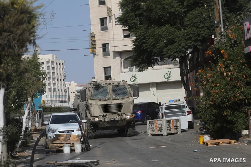 Israeli soldiers and military vehicles are deployed along streets in the West Bank city of Hebron, on October 25, 2026, as an Israeli military operation continues for the third consecutive day. The operation involves roa...