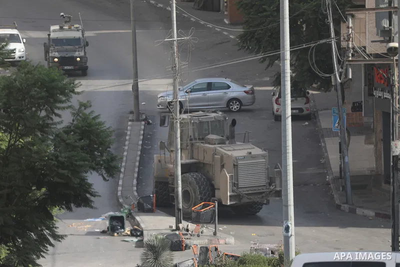 Israeli soldiers and military vehicles are deployed along streets in the West Bank city of Hebron, on October 25, 2026, as an Israeli military operation continues for the third consecutive day. The operation involves roa...