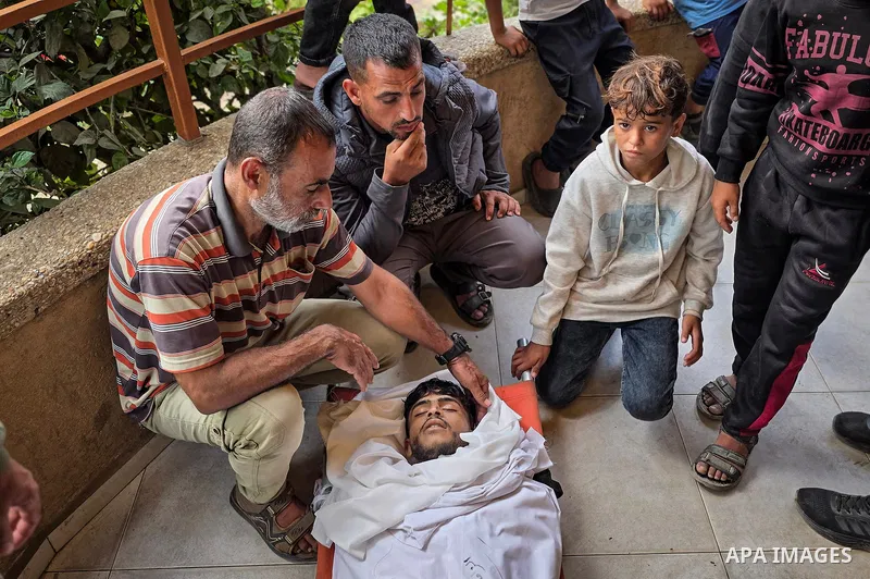 Mourners attend the funeral of Palestinians Hussam al-Zamli, child Jouri al-Soufi and Tamer Abu Sneima in Khan Younis, southern Gaza Strip, on October 26, 2026. The three were killed by Israeli forces' gunfire in the al-...