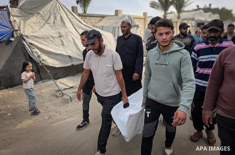 Mourners attend the funeral of Palestinians Hussam al-Zamli, child Jouri al-Soufi and Tamer Abu Sneima in Khan Younis, southern Gaza Strip, on October 26, 2026. The three were killed by Israeli forces' gunfire in the al-...