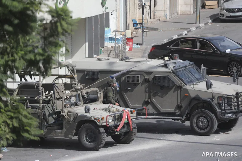 Israeli soldiers and military vehicles are deployed along streets in the West Bank city of Hebron, on October 26, 2026, as an Israeli military operation continues for the fourth consecutive day. The operation involves ro...