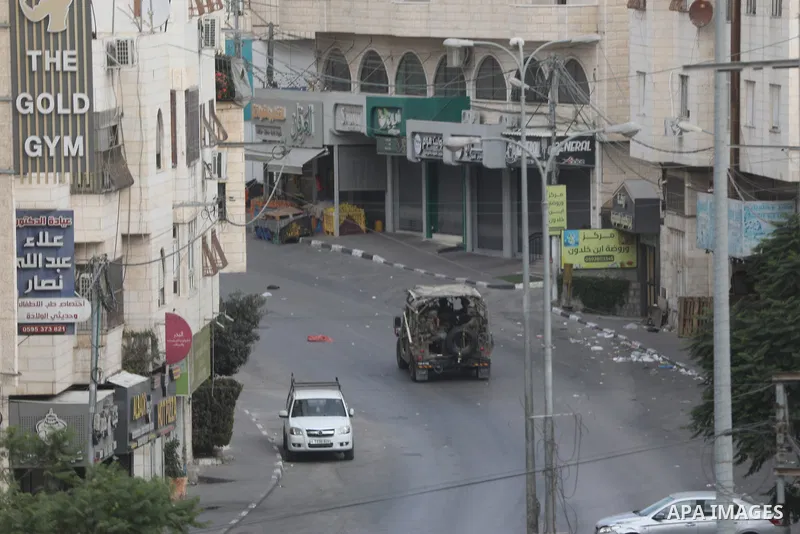 Israeli soldiers and military vehicles are deployed along streets in the West Bank city of Hebron, on October 26, 2026, as an Israeli military operation continues for the fourth consecutive day. The operation involves ro...